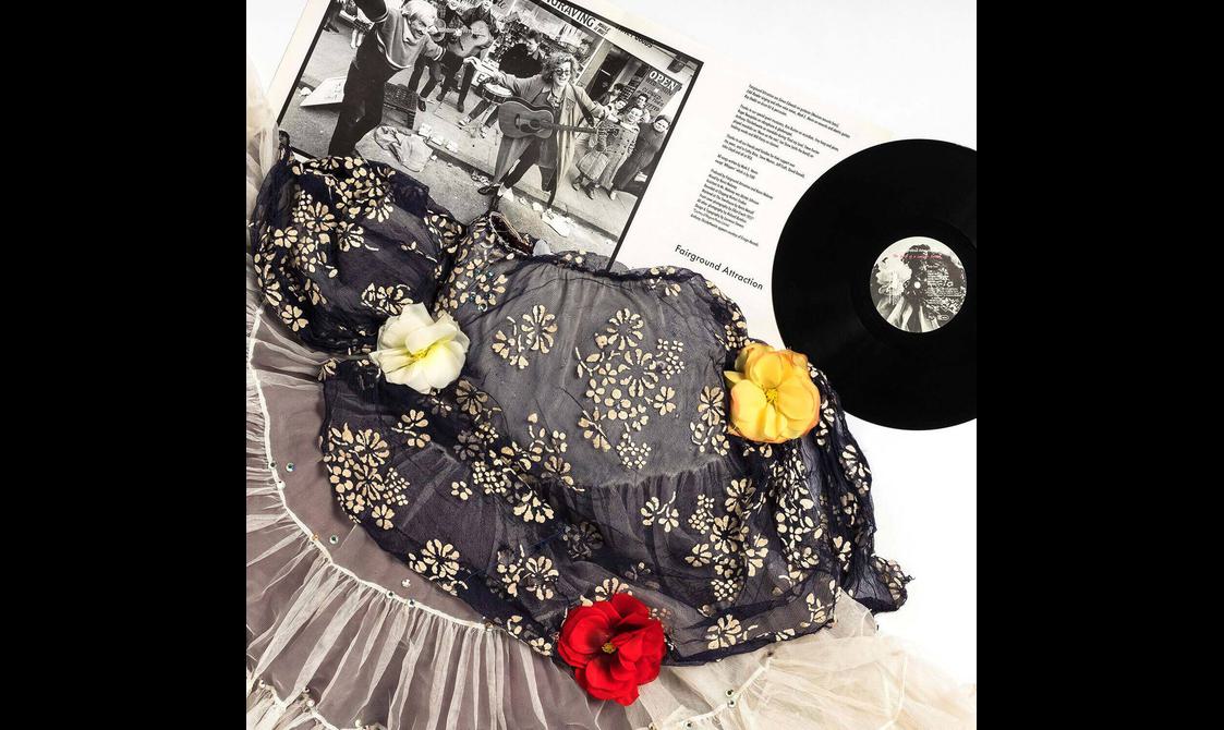A top and skirt lying on top of a vinyl record.