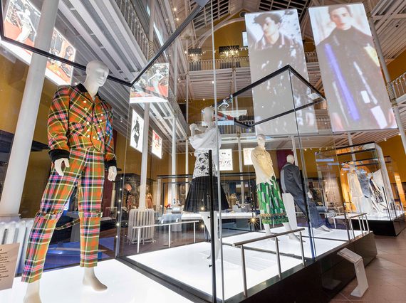 Mannequins wearing colourful clothes on display in a museum