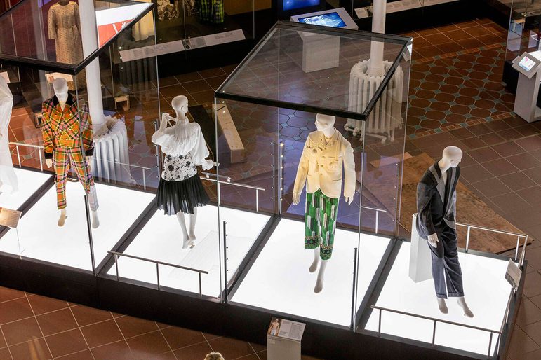 Mannequins wearing colourful clothes on display in a museum.