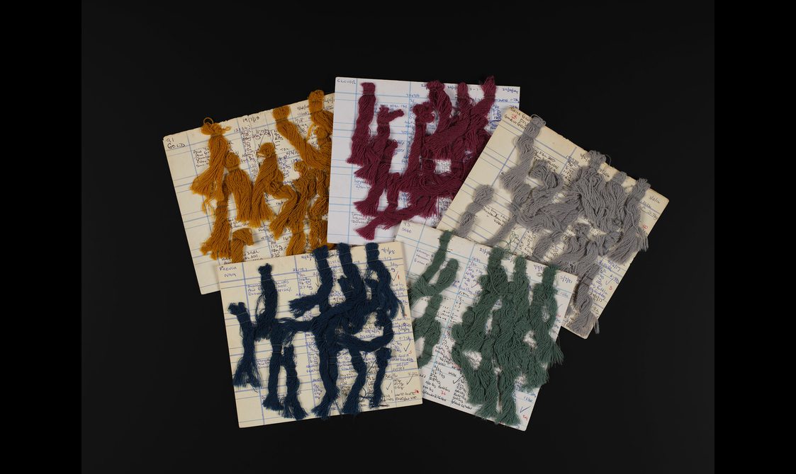 Five square cards with samples of coloured wool.