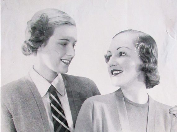 Black and white photograph of two women modelling Pringle of Scotland cardigans.