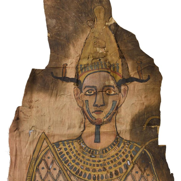 A yellowed linen textile with an Egyptian god painted on its surface.