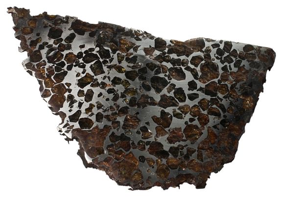 A mineral sample showing brown coloured stones on a metalic surface