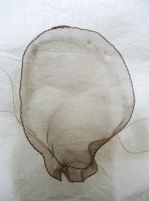 A piece of brown transparent fabric gathered into an oval shape.