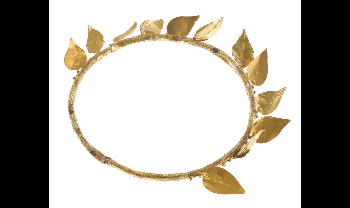A circular gold wreath with a simple band with gold leaves attached.