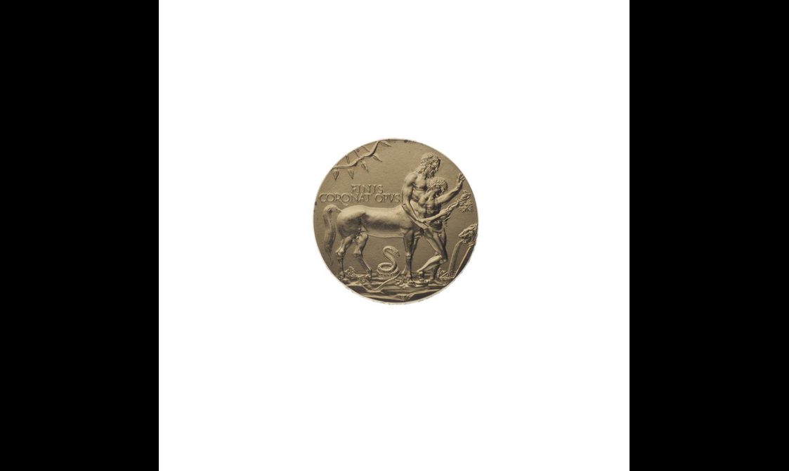 A round gold medal with a half man half horse figure on it holding another person