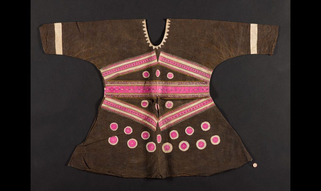 A brown long sleeved blouse laid flat decorated with pink and cream detailing.