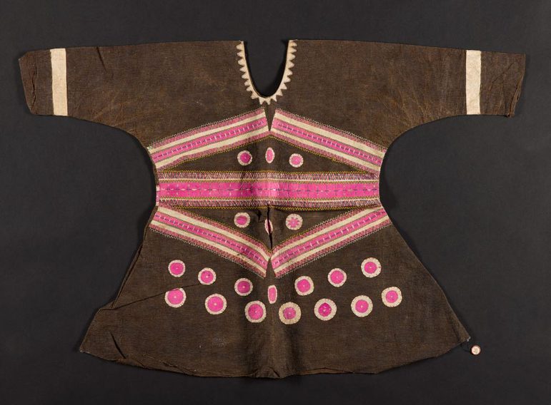 A brown long sleeved blouse laid flat decorated with pink and cream detailing.