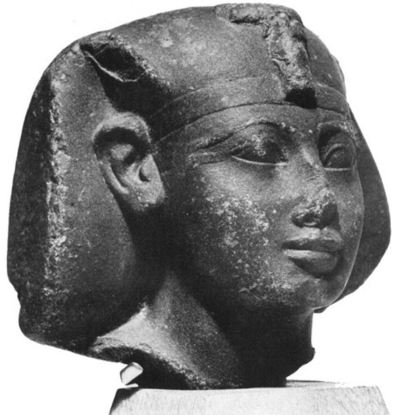 A stone statue of the head of an Egyptian king.