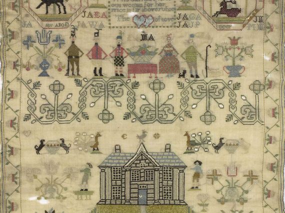 A complex needlework piece depicting people, animals, and flowers.