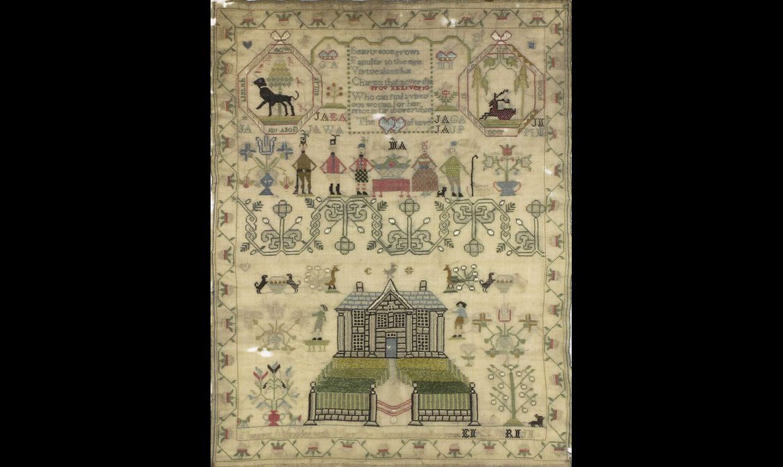 A complex needlework piece depicting people, animals, and flowers.