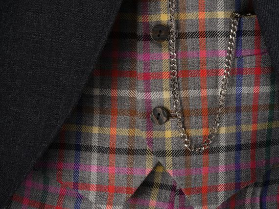 A colourful tartan waistcoat with a pocket watch chain