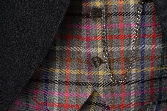 A colourful tartan waistcoat with a pocket watch chain