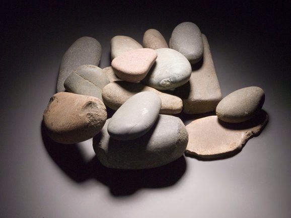 A pile of small, mostly smooth, white, grey, and tan stones.