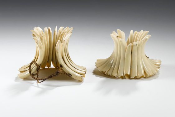 Two funnels against the white background from a crescent shaped ivory tusks.