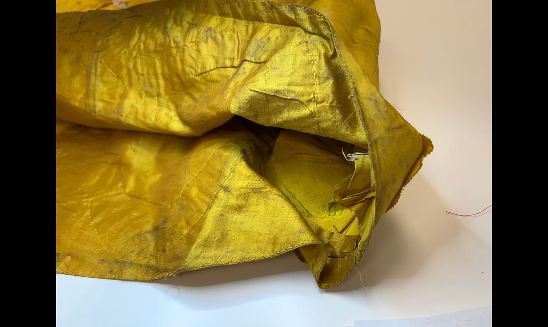 A close up of the inside lining of an ornate yellow garment