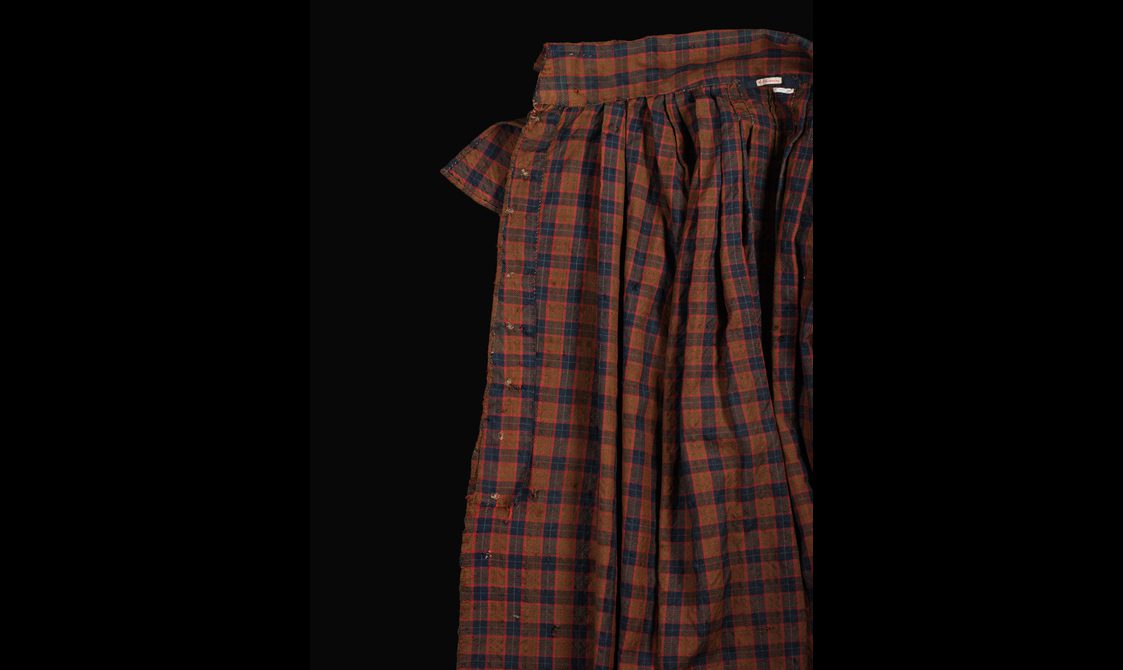 Inside of a brown, navy, and red tartan cloak