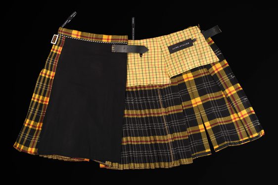 A yellow and black kilt made up of patchwork textiles.