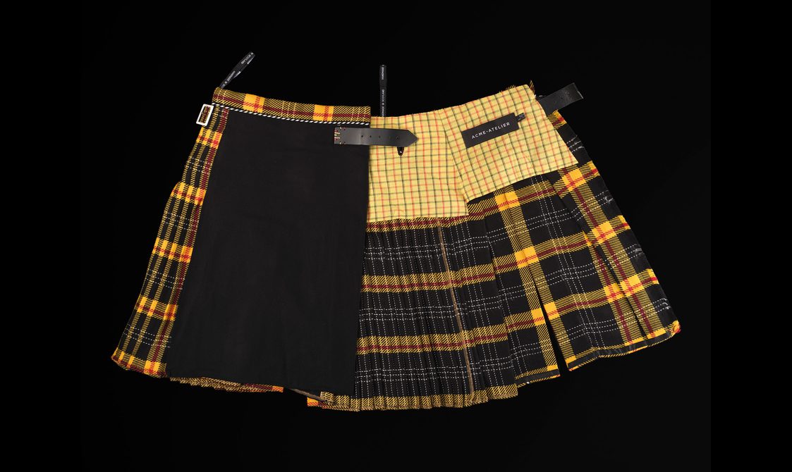 A yellow and black kilt made up of patchwork textiles.