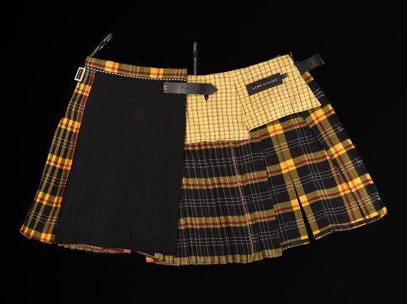 A yellow and black kilt made up of patchwork textiles.