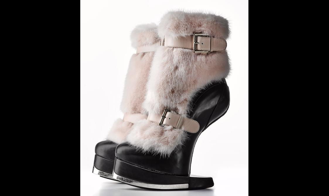 A pair of black boots covered in white fur