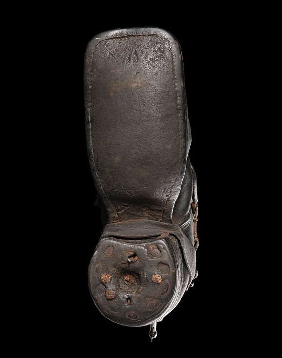 Close up of jack boot showing stacked leather heel and square toe.