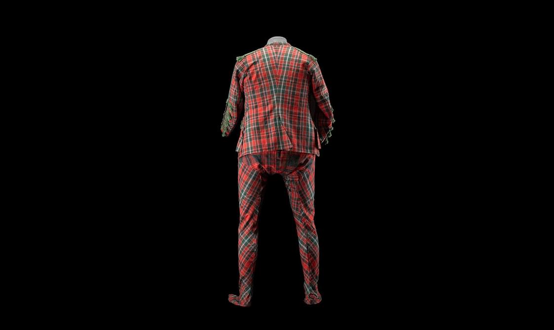 The back view of a red and green tartan full body suit.