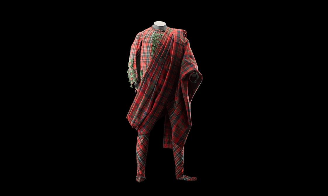 Front view of a red and green tartan full body suit with a tartan fly plaid.