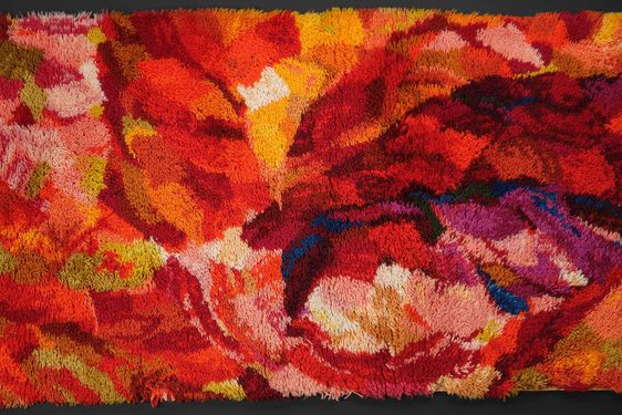 A colourful abstract textile design with colours of red, orange, yellow, and blue.