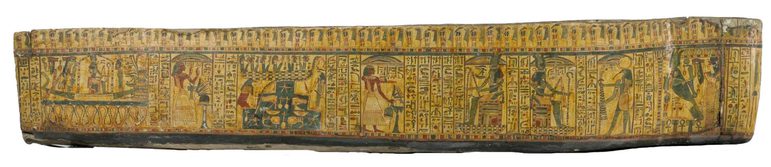 A side view of an ancient Egyptian coffin decorated with detailed illustrations and hieroglyhics.
