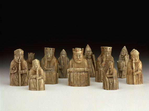 A group of chess pieces resembling kings, knights, and clergymen made from ivory