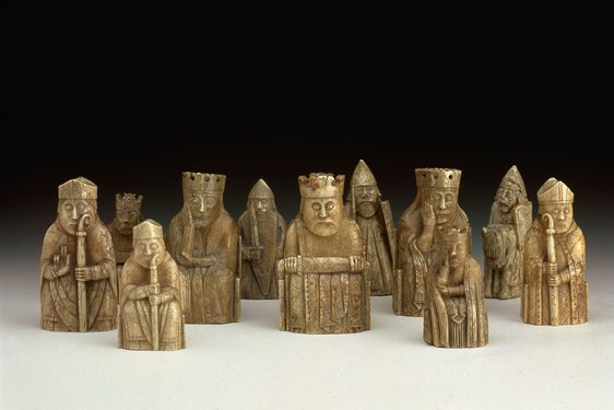 A group of chess pieces resembling kings, knights, and clergymen made from ivory