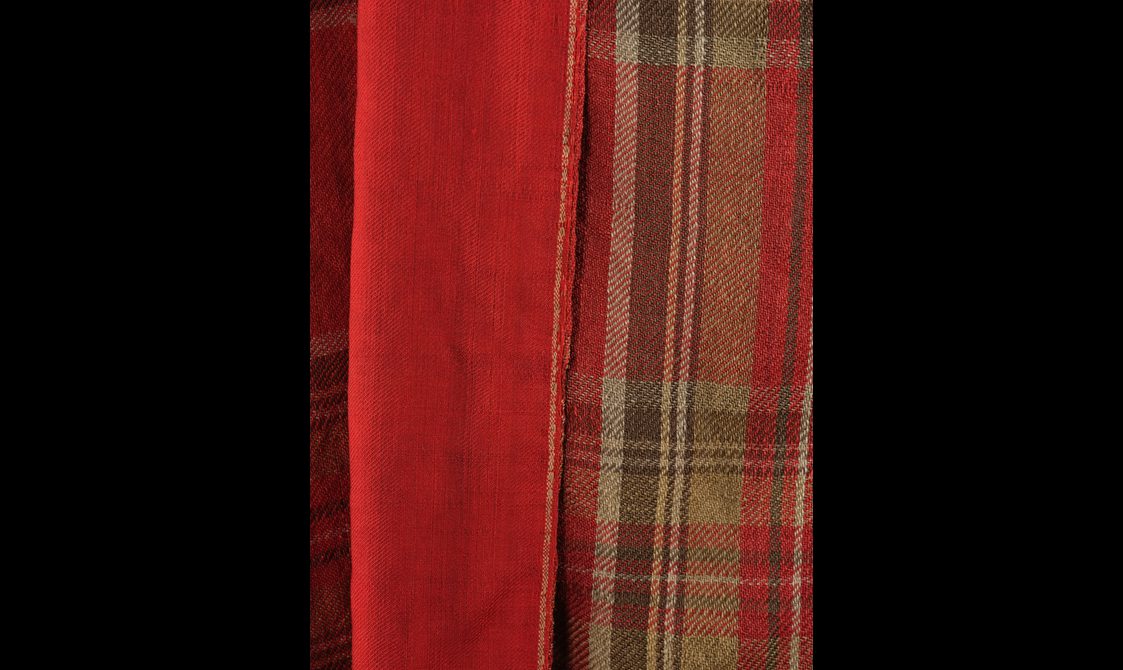 Detail of the lining of a red tartan cloak