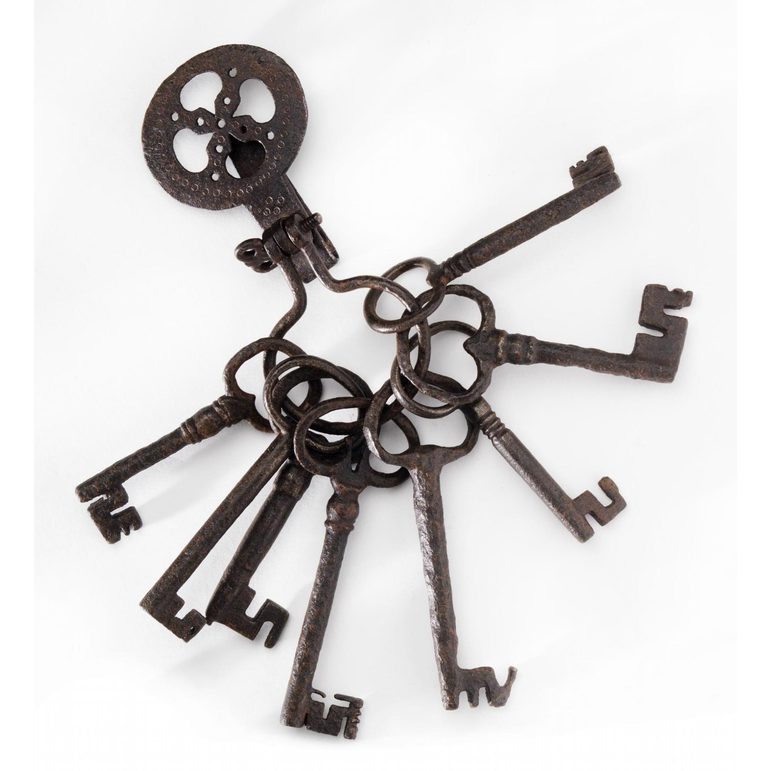 A set of ion keys all looped together on an iron ring