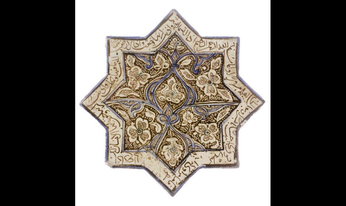 An eight pointed star shaped tile with floral patterns and Arabic script