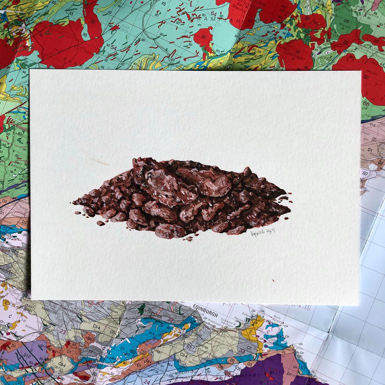 An illustration of dark reddish rocks on a white piece of paper. The illustration is photographed against a geological map of Scotland.