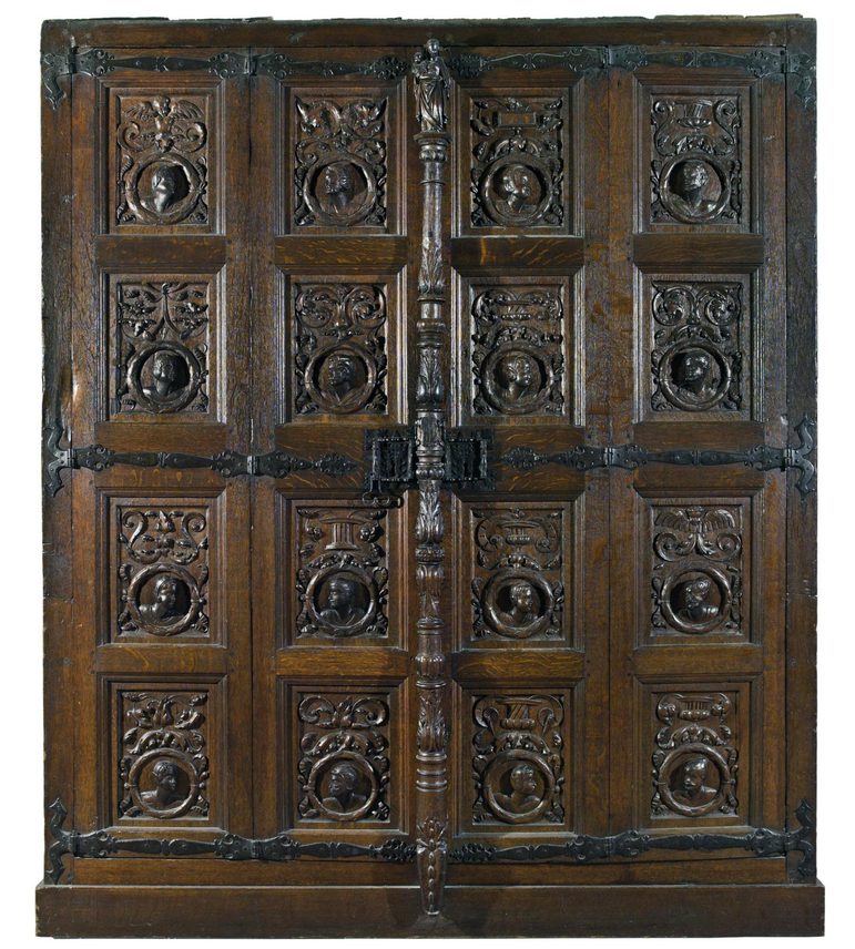 An oak cabinet with highly decorative carved panels