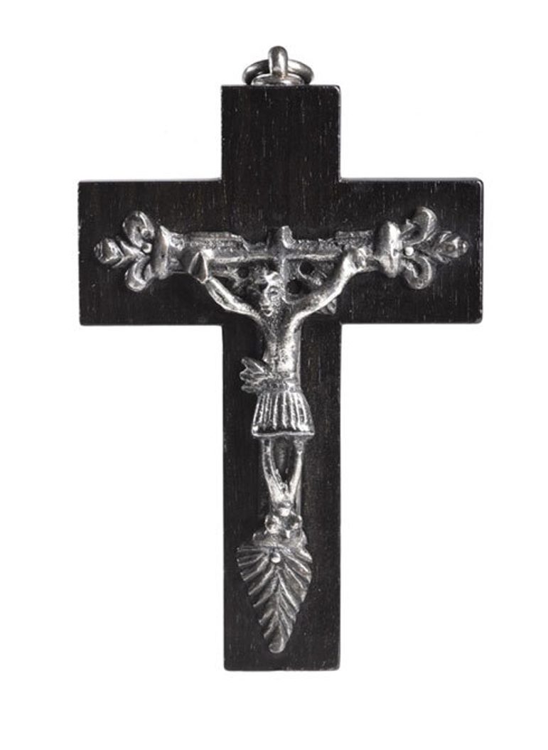 A black and silver cross pendant depicting Jesus hanging on a cross.