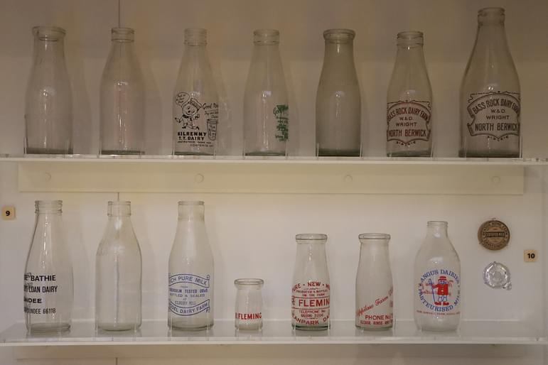 Fourteen milk bottles from different dairies across Scotland