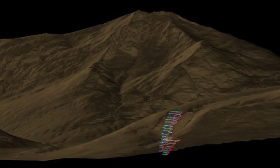 A computer model of a mountain with the map of where a mine runs into it shown with bright lines near the bottom of the image.