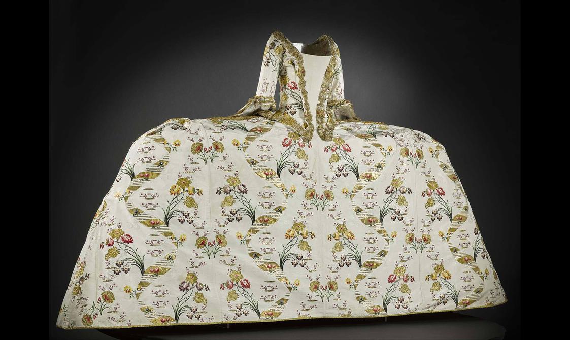 An extravagant gown with a wide skirt and complex pattern designs.