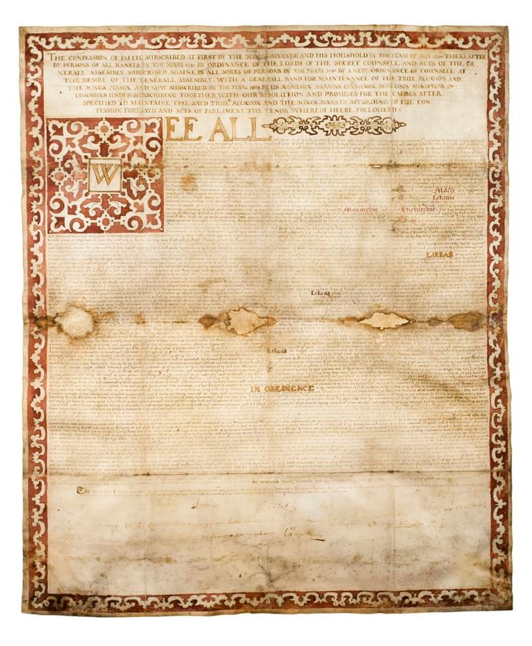 An old yellowed document with a decorative border and fine small text.