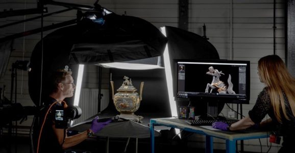 A photography studio where two photographers are digitising an ornate vase.