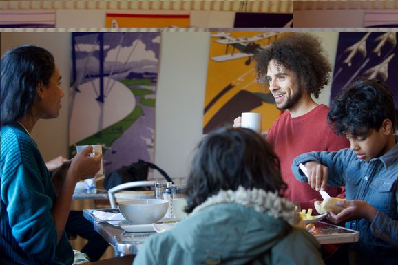 A family sitting at a table eating lunch