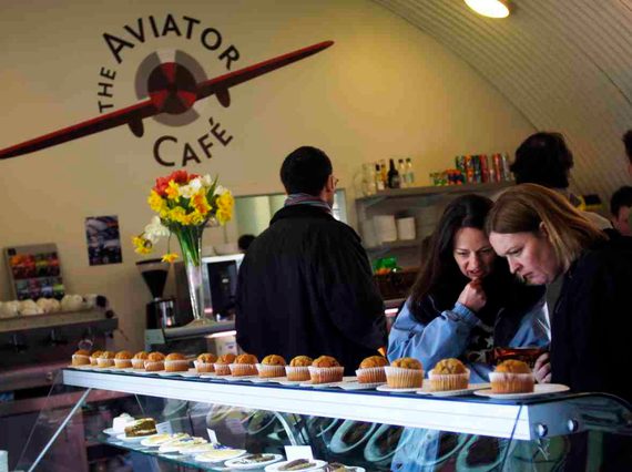Visitors looking at an array of pastries in a café