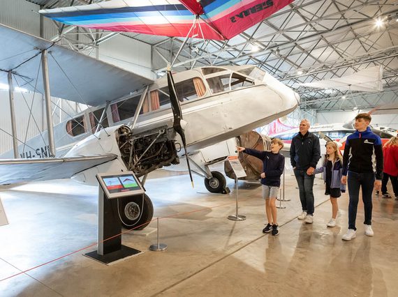 A family looking at aircraft in the Civil Aviation hangar at the National Museum of Flight.
