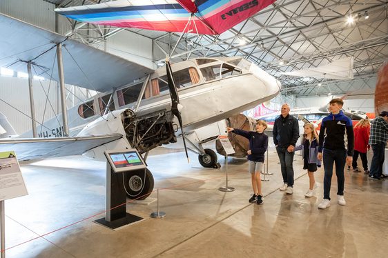 A family looking at aircraft in the Civil Aviation hangar at the National Museum of Flight.