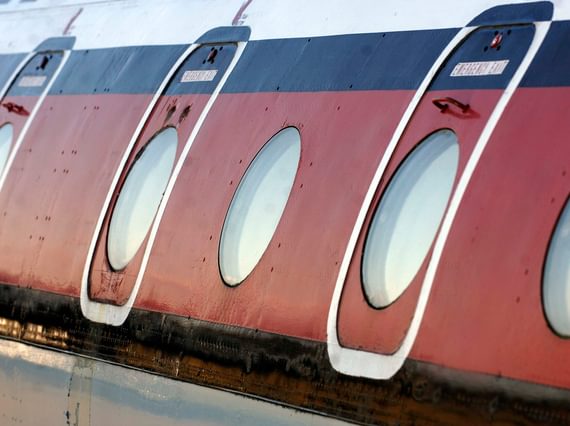 Close up view of the outside of the Comet 4C aircraft, focusing on the cabin windows.