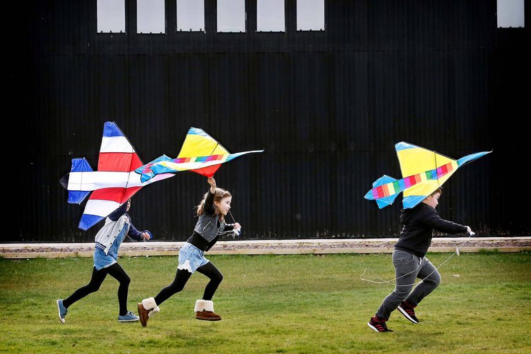 Children running with aeroplane kites at the Naitonal Museum of Flight