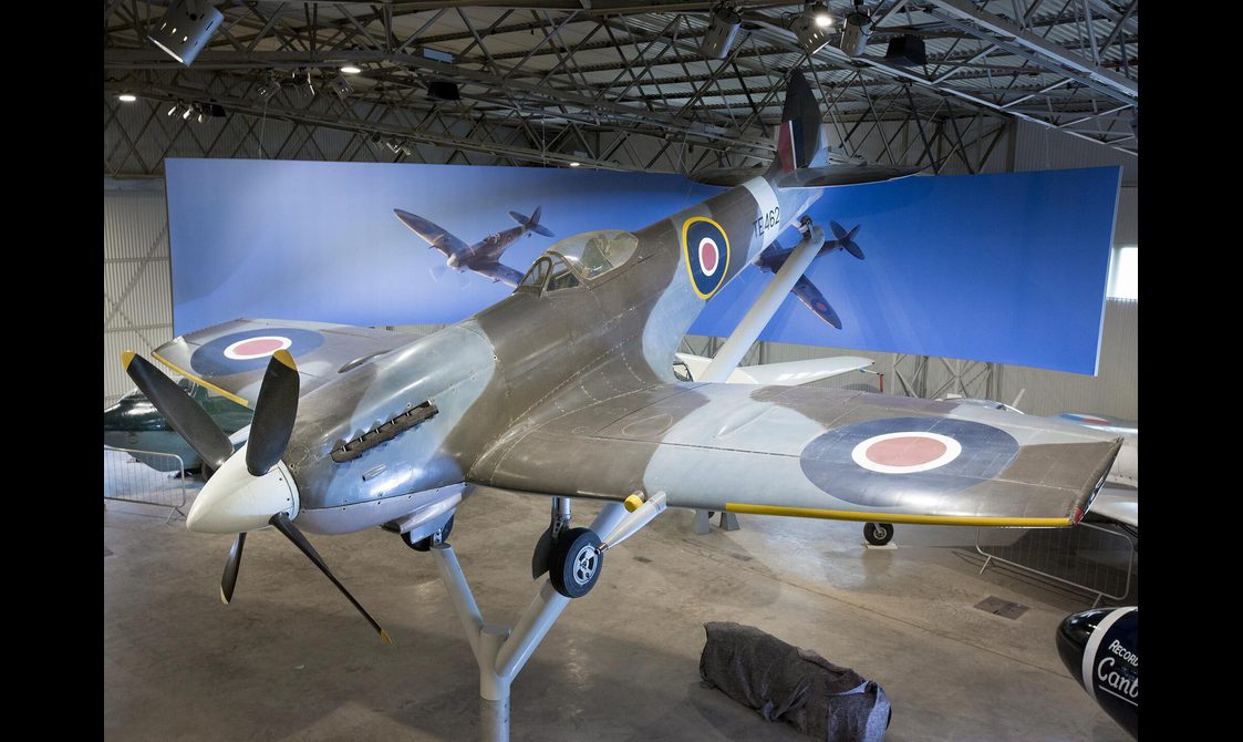 A Supermarine Spitfire aircraft on display on a stand in the Military Aviation hangar.